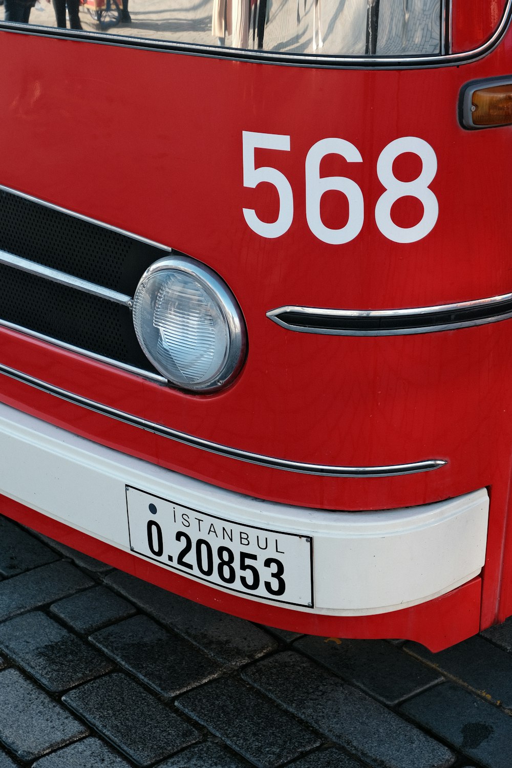 a close up of the front of a red bus