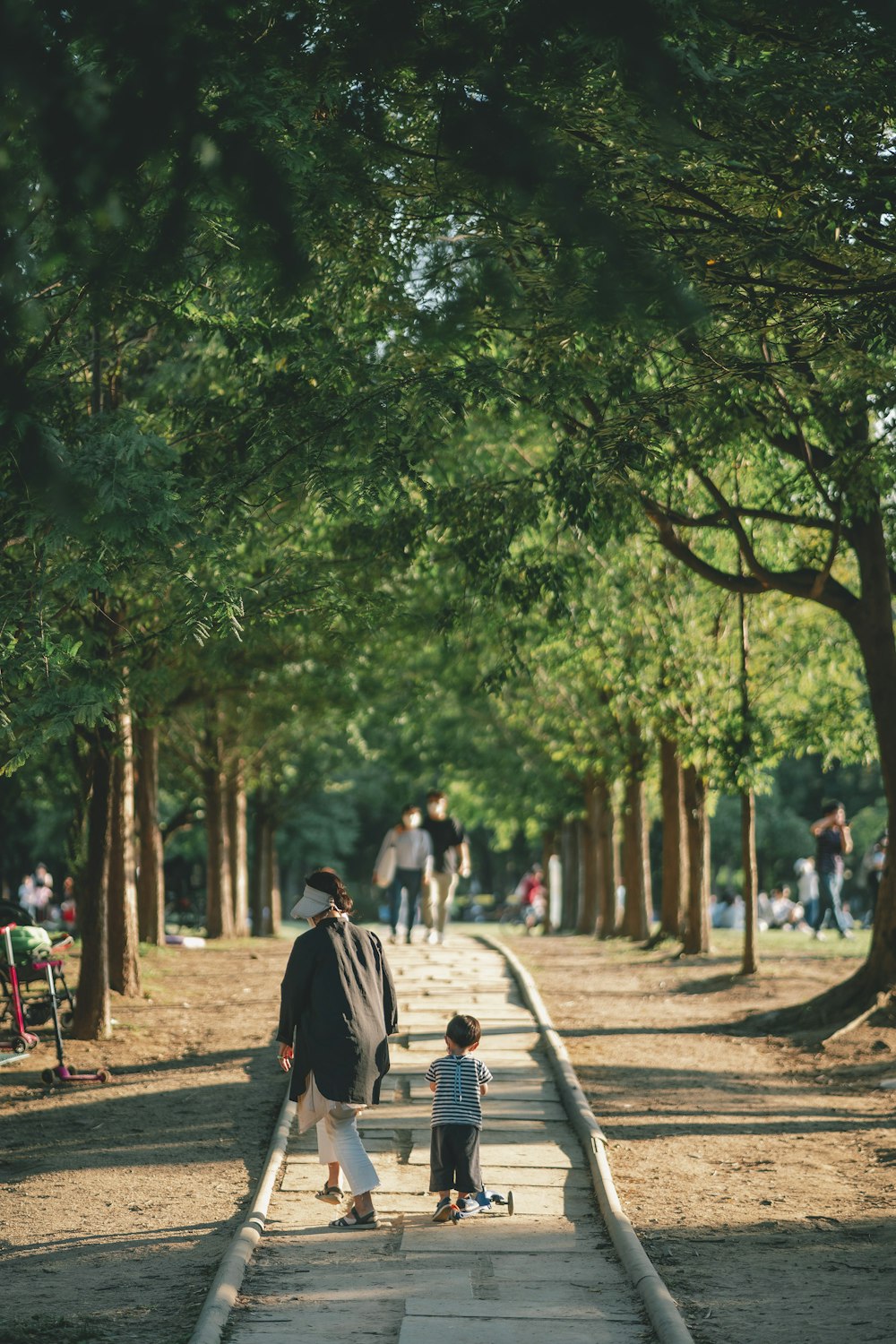 a man and a child are walking down a path