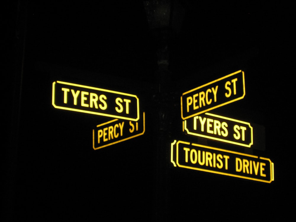 street signs lit up in the dark at night