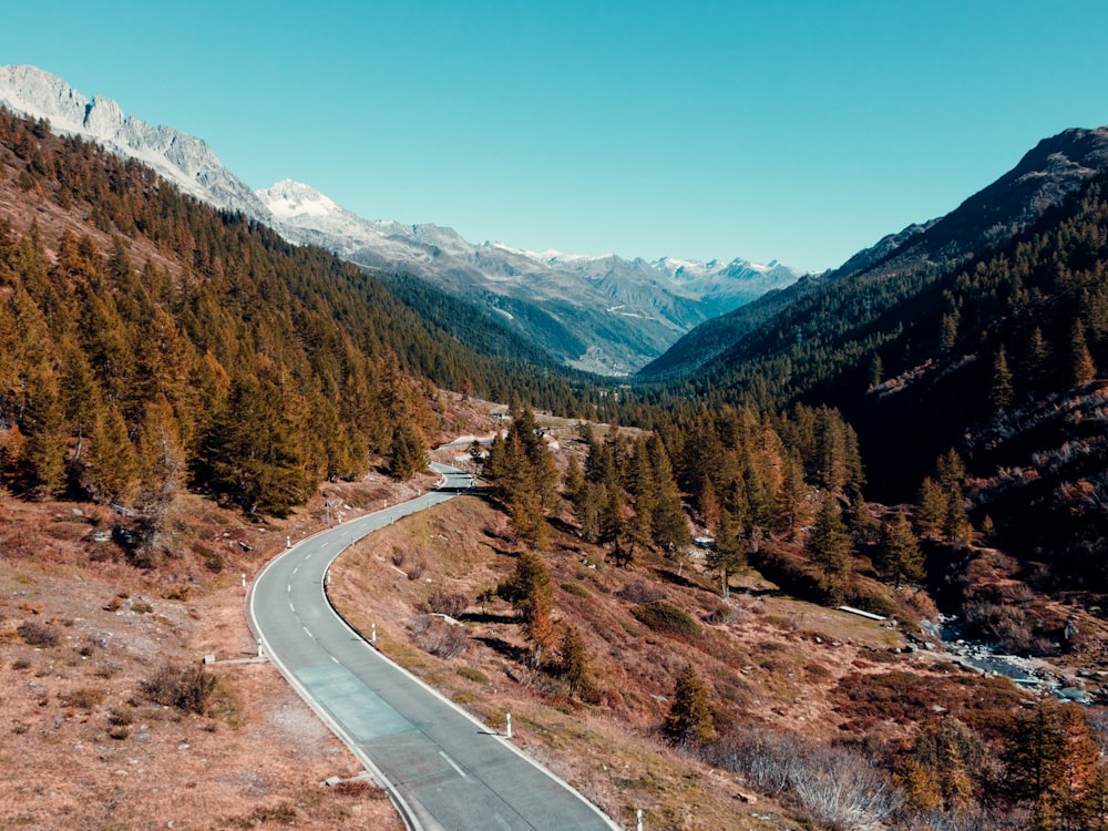 a winding road in the middle of a mountain range