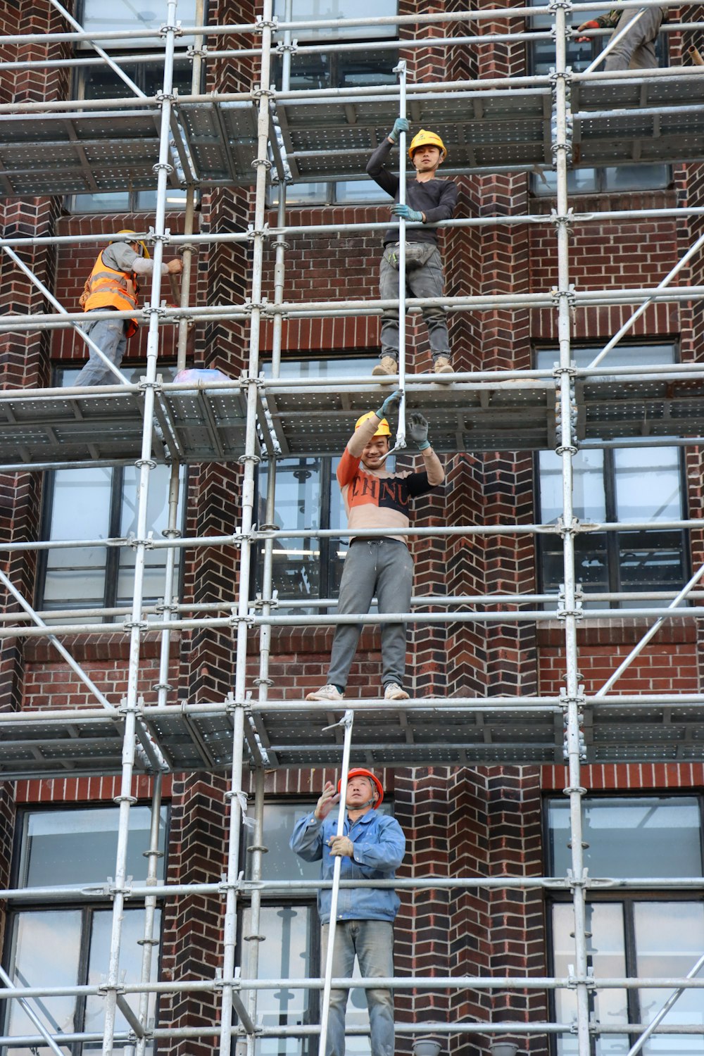 a group of people on scaffolding working on a building