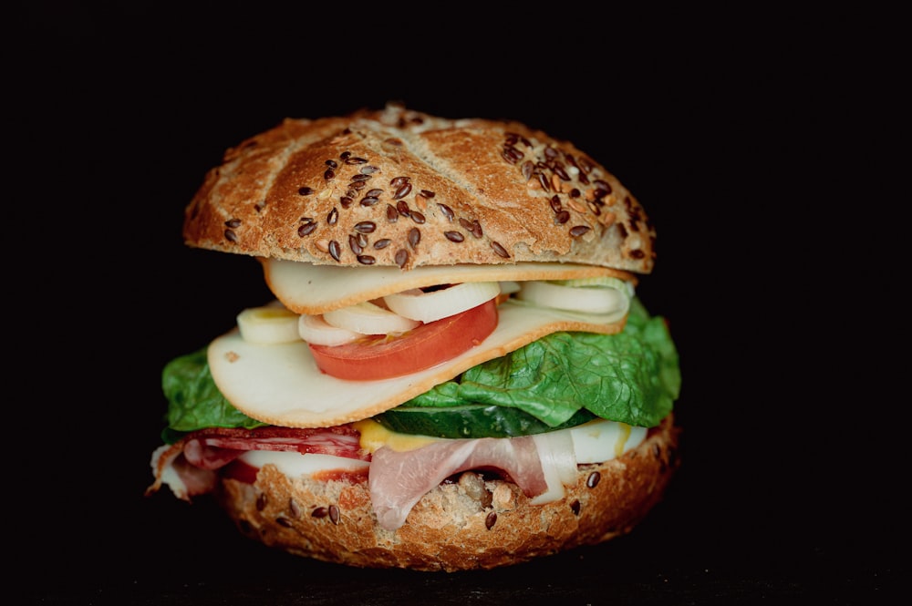 a close up of a sandwich on a black background