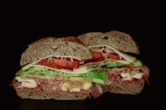 a close up of a sandwich on a black surface
