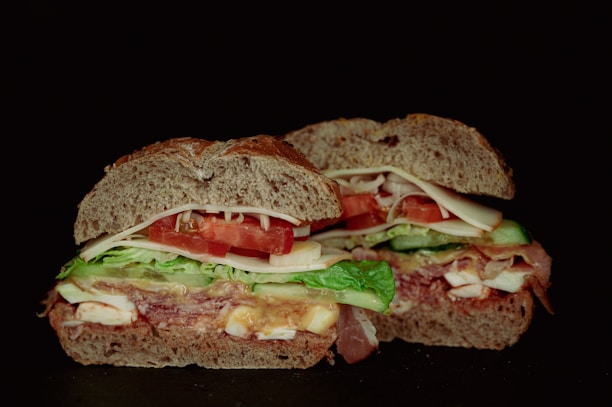 a close up of a sandwich on a black surface