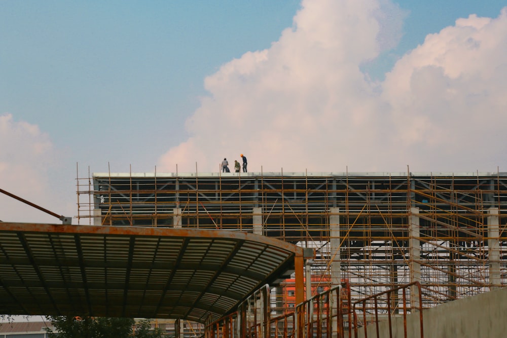 a couple of people standing on top of a building under construction