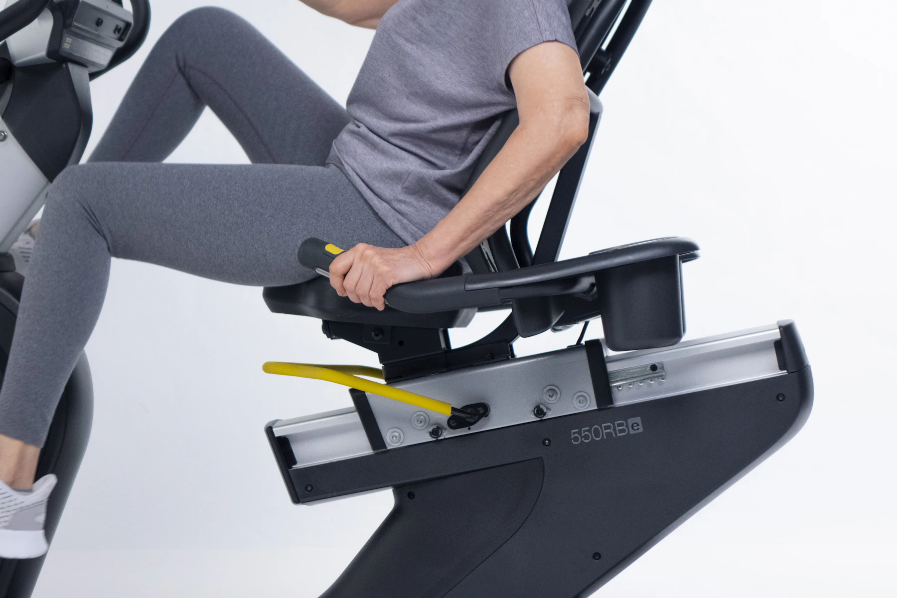 Adult exercising on a recumbent stationary bike