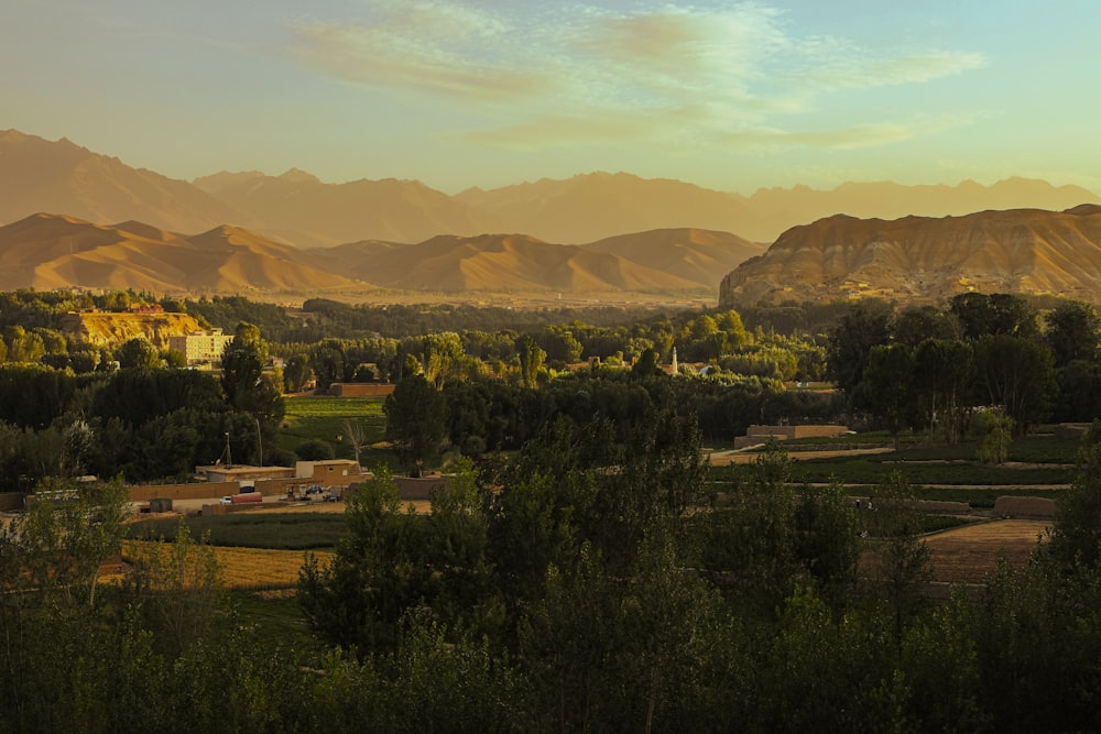 a scenic view of a valley with mountains in the background