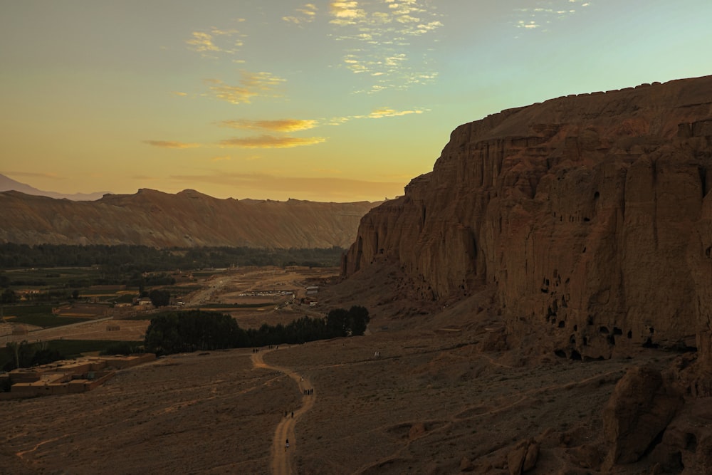 a desert landscape with a road going through it