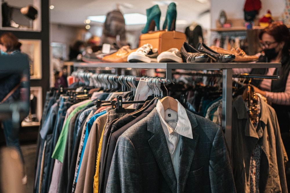 a rack of clothes and shoes in a store