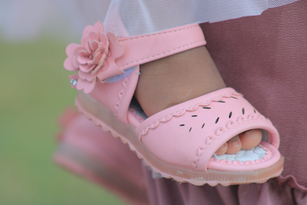 a close up of a child's pink shoes