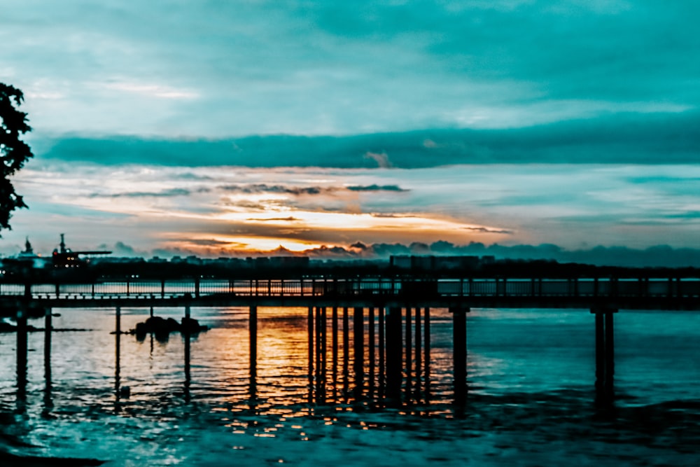 a body of water with a bridge in the background