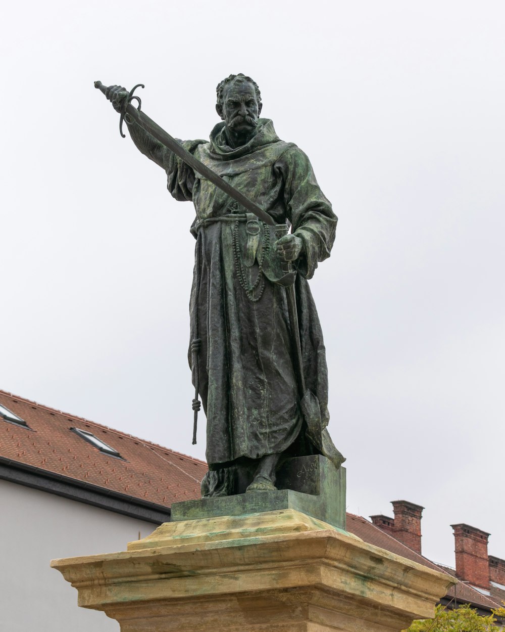 a statue of a man holding a staff