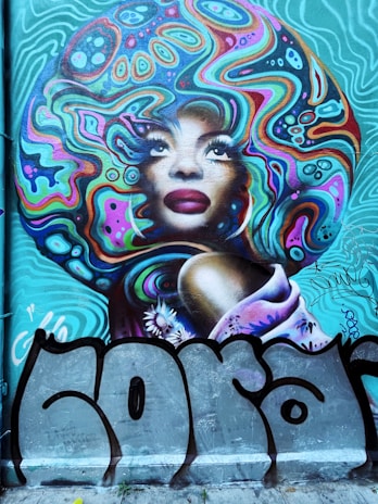 A vibrant street mural celebrating African American heritage with colorful portraits and symbols.