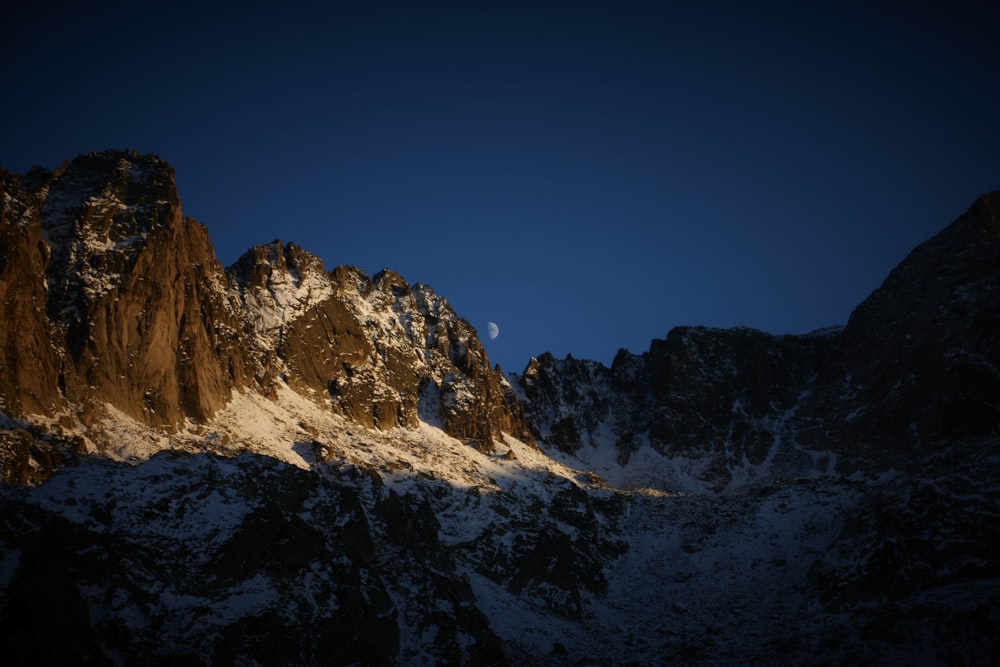 a snow covered mountain with a blue sky in the background