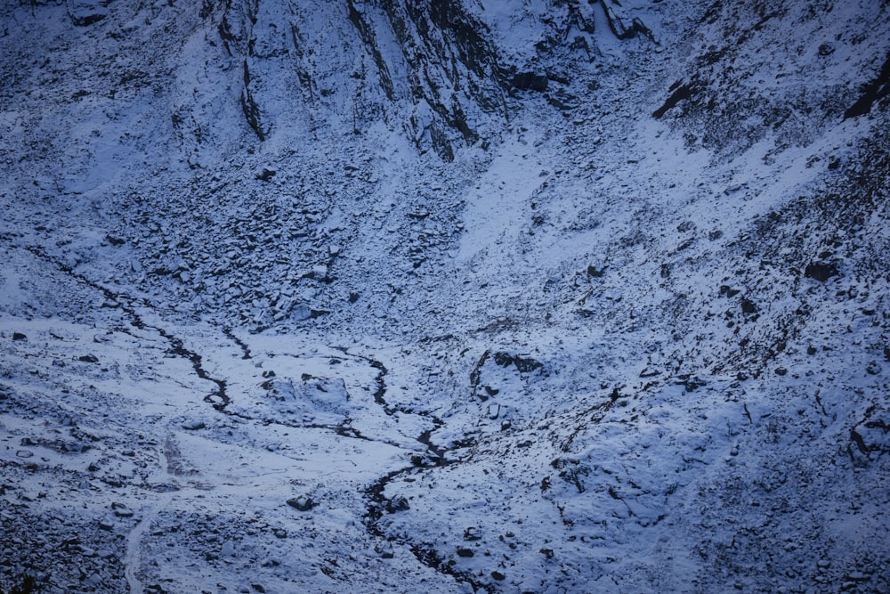 a snow covered mountain with a river running through it