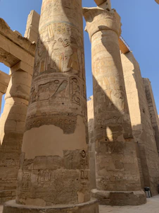 A close-up of weathered Egyptian megaliths bathed in golden sunlight, hinting at hidden stories.