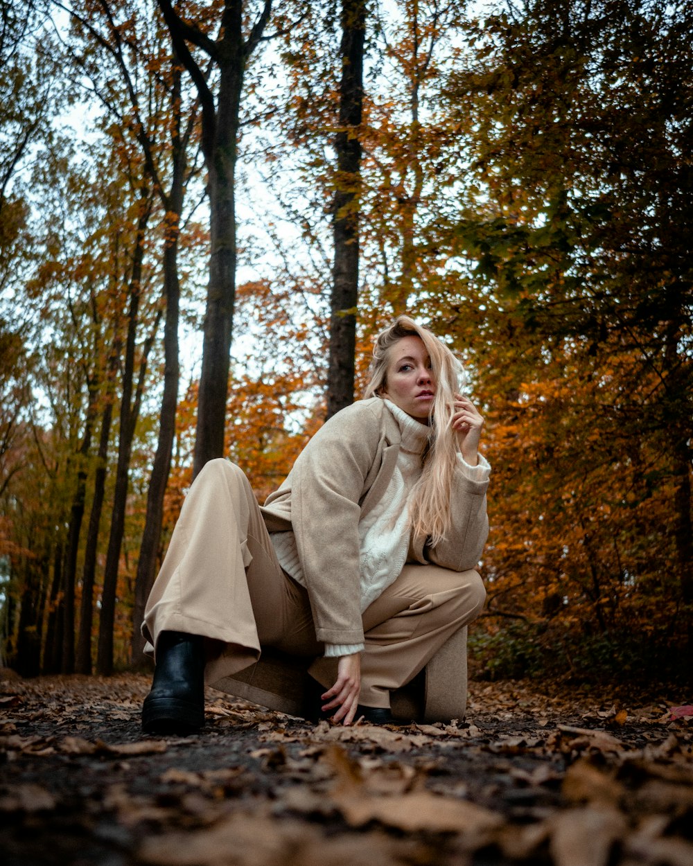 Eine Frau sitzt auf dem Boden im Wald
