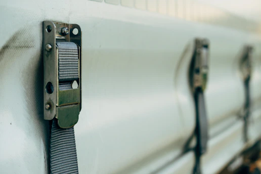 a close up of a metal latch on a white truck