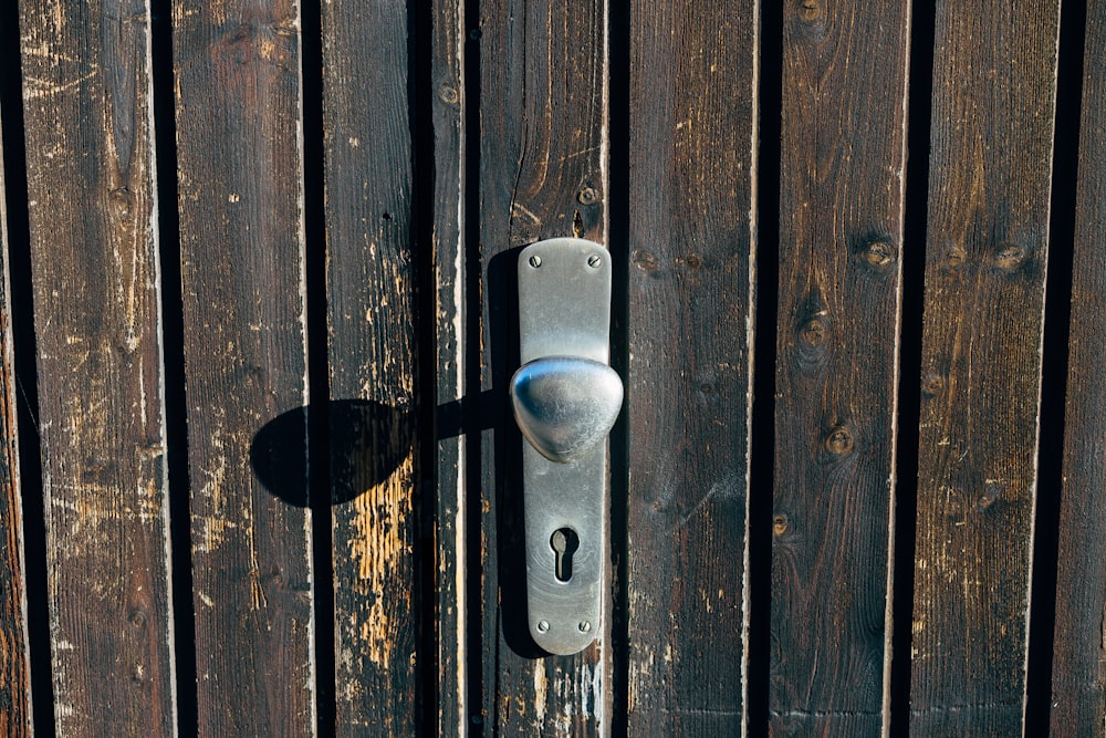 a metal door handle on a wooden door