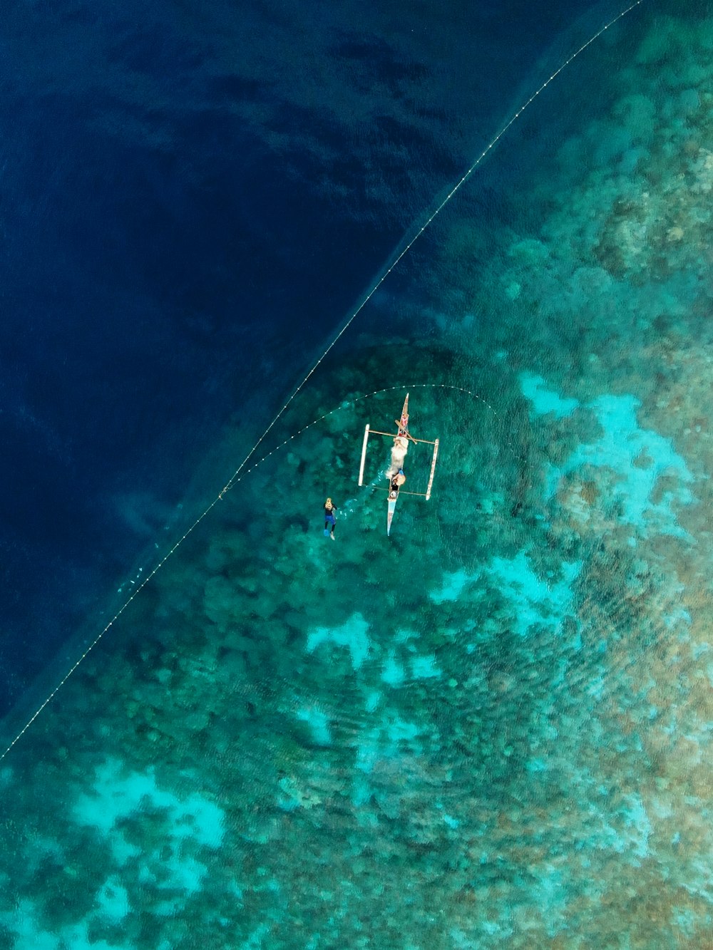 two people are in the water on a boat