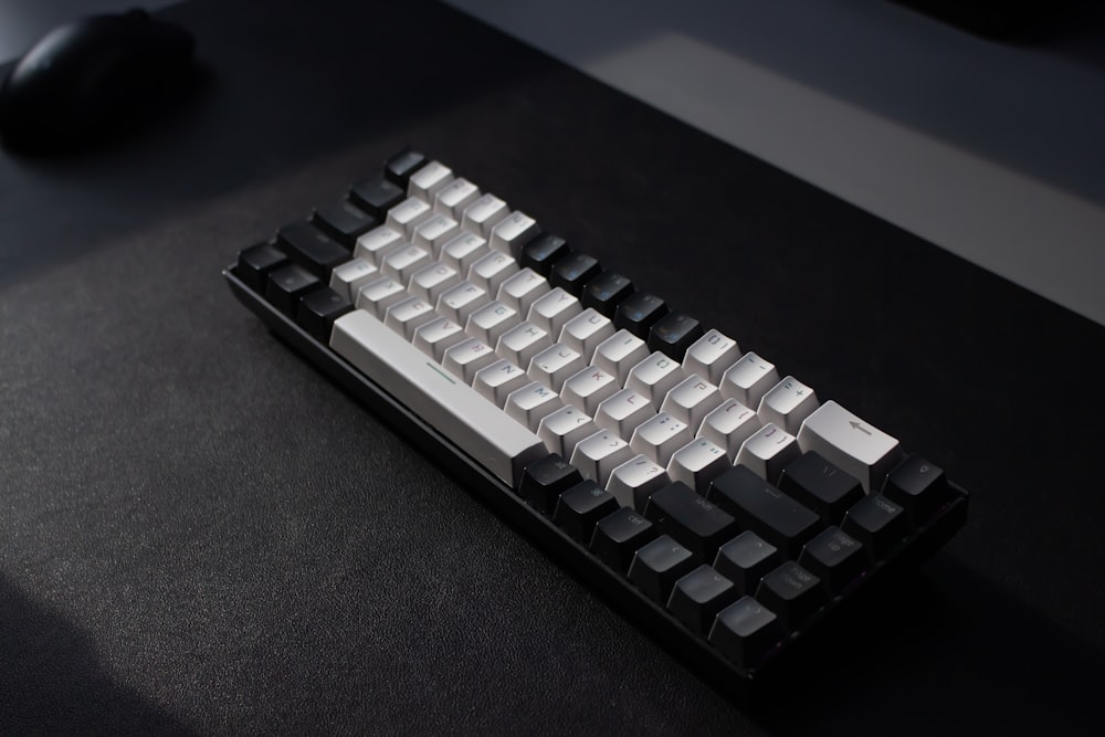 a computer keyboard sitting on top of a desk