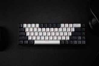 a keyboard and a mouse on a black surface