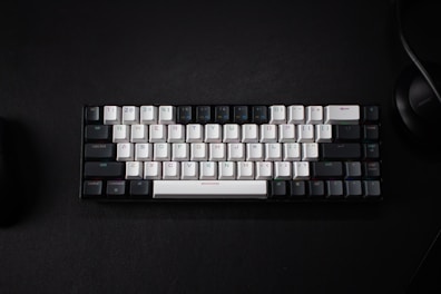 a keyboard and a mouse on a black surface