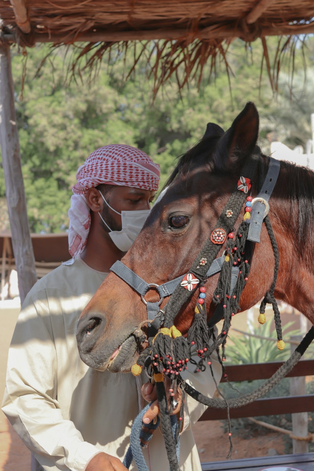 a man in a white shirt is petting a horse