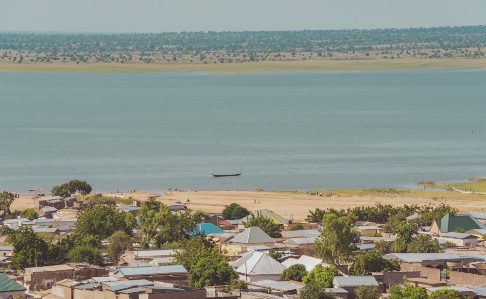 a view of a town with a body of water in the background