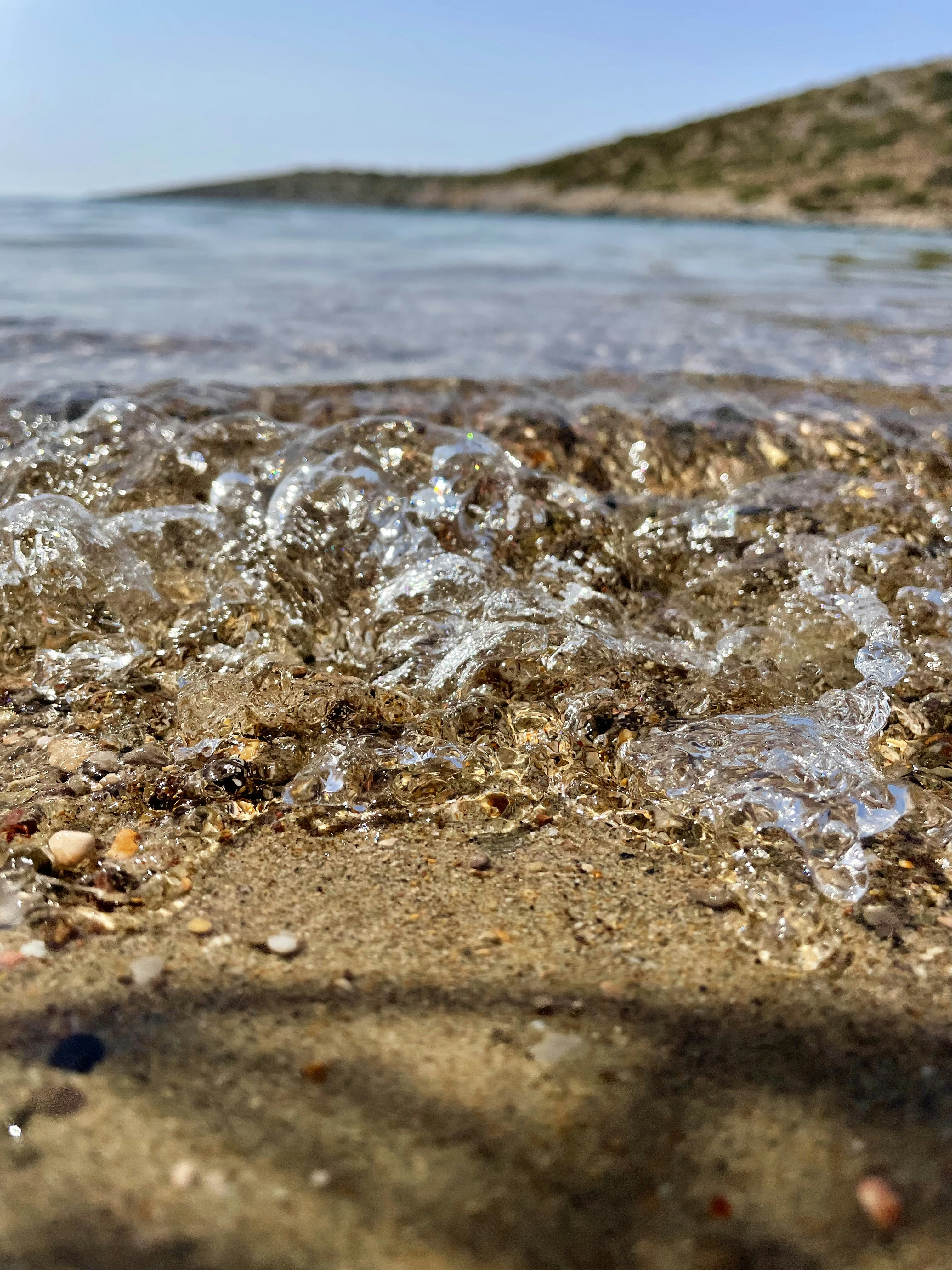 a close up of water and sand on a beach