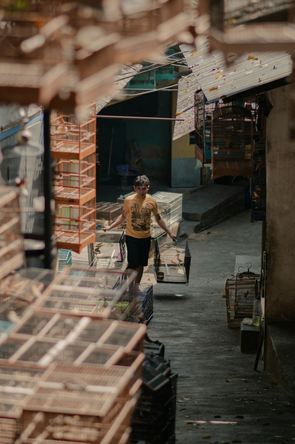 a woman walking down a street next to a pile of boxes