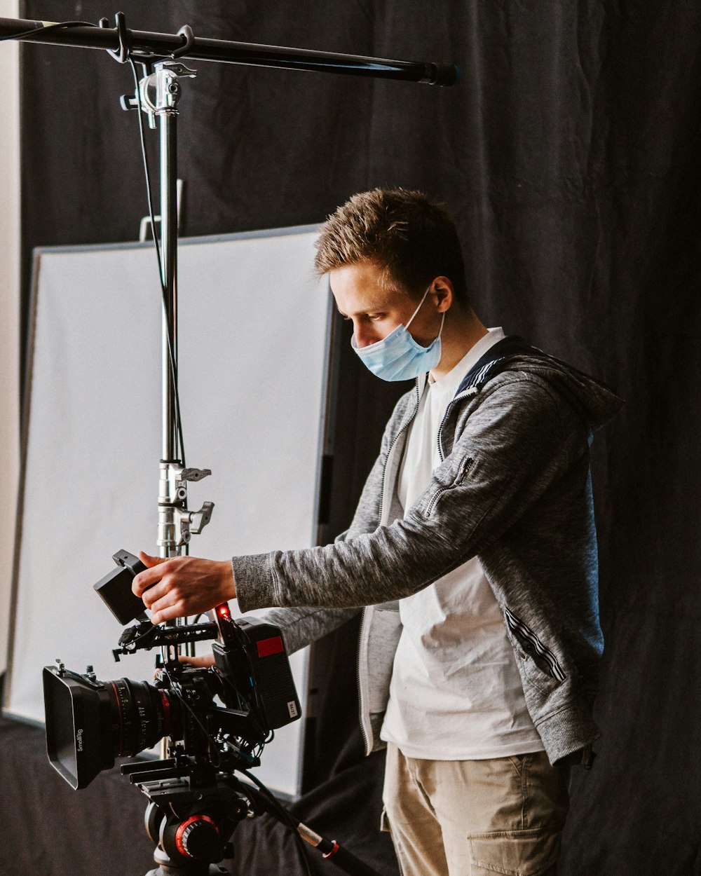 a man wearing a face mask while standing in front of a camera