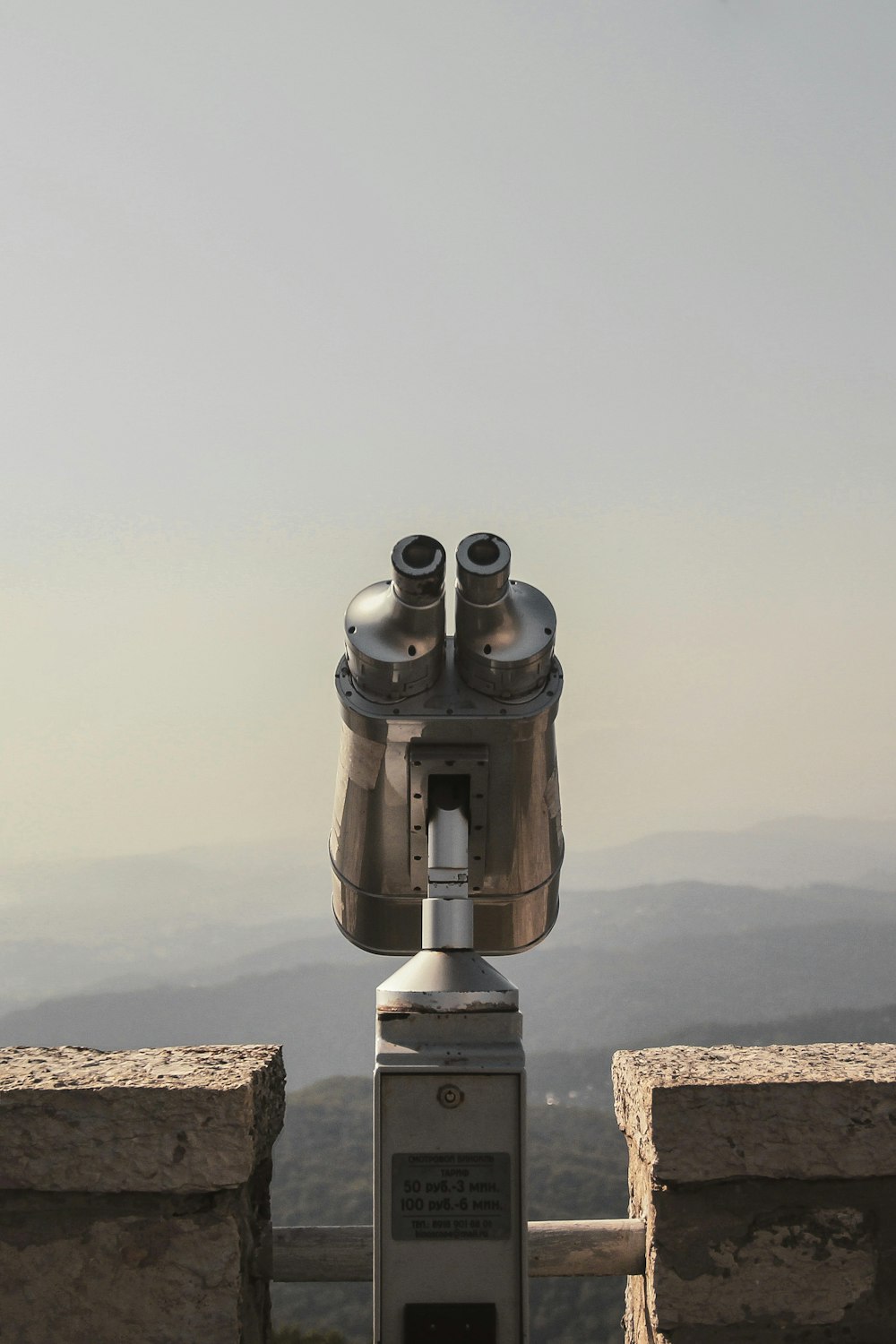 a metal object on top of a stone wall