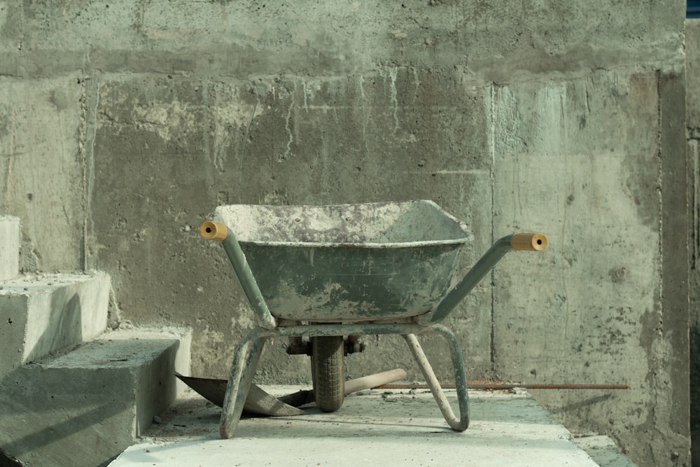 a wheelbarrow sitting on top of a cement block