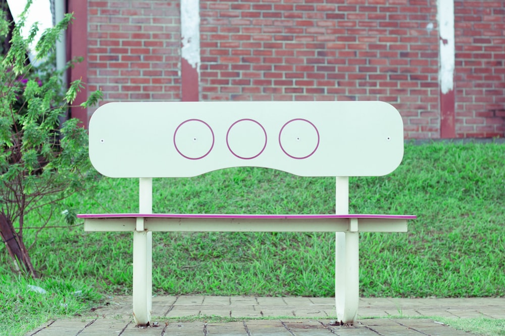 a white bench with three circles on it