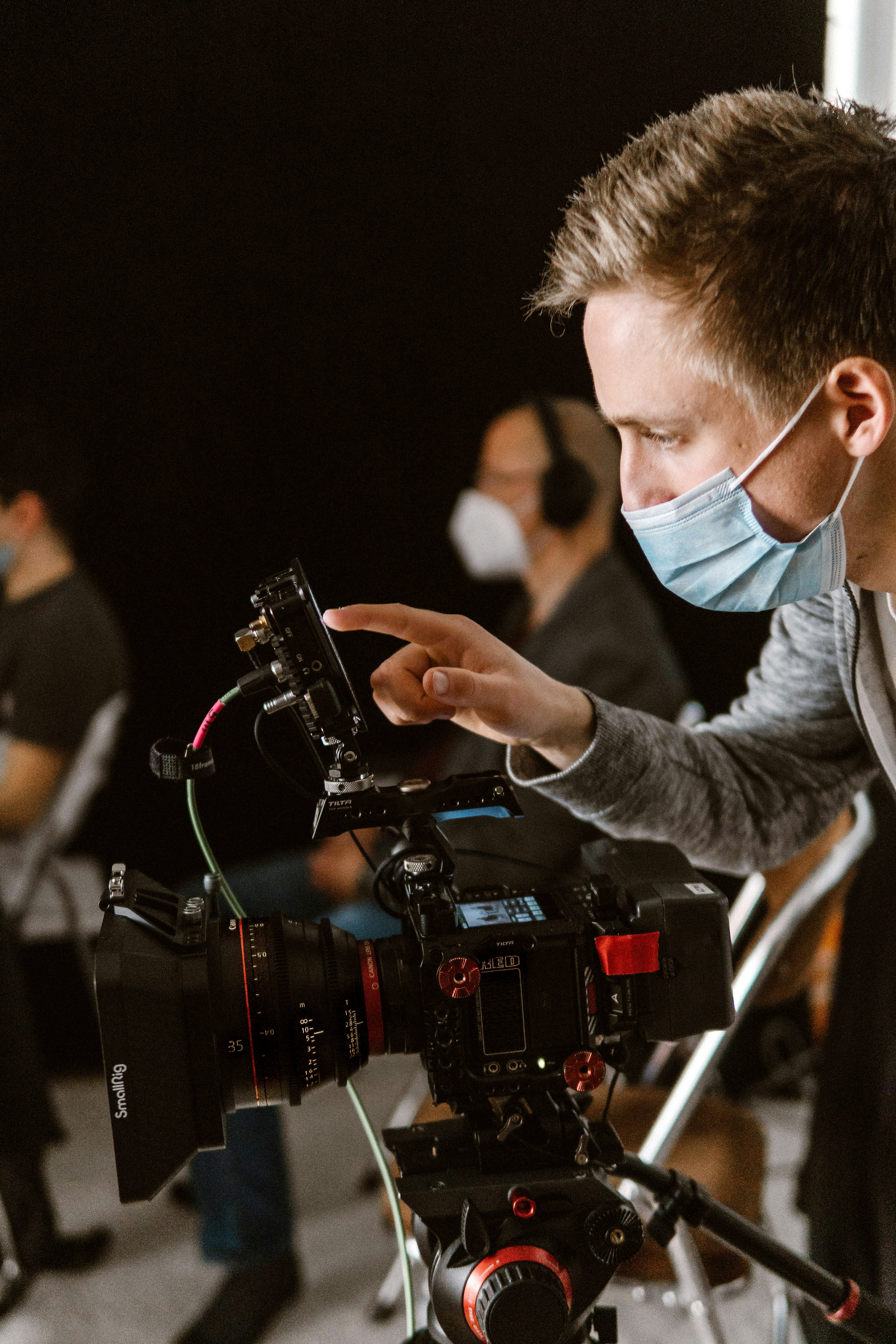 a man wearing a face mask and holding a camera