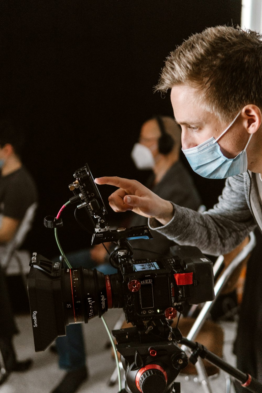 a man wearing a face mask and holding a camera