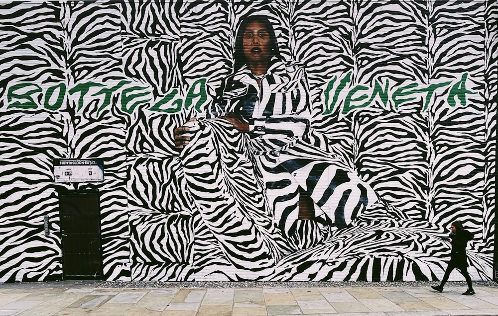 a man standing in front of a zebra print wall