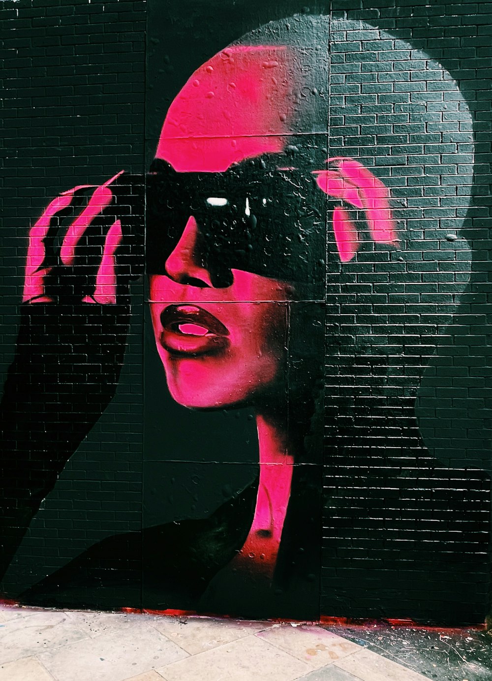 a painting of a woman with sunglasses on her face