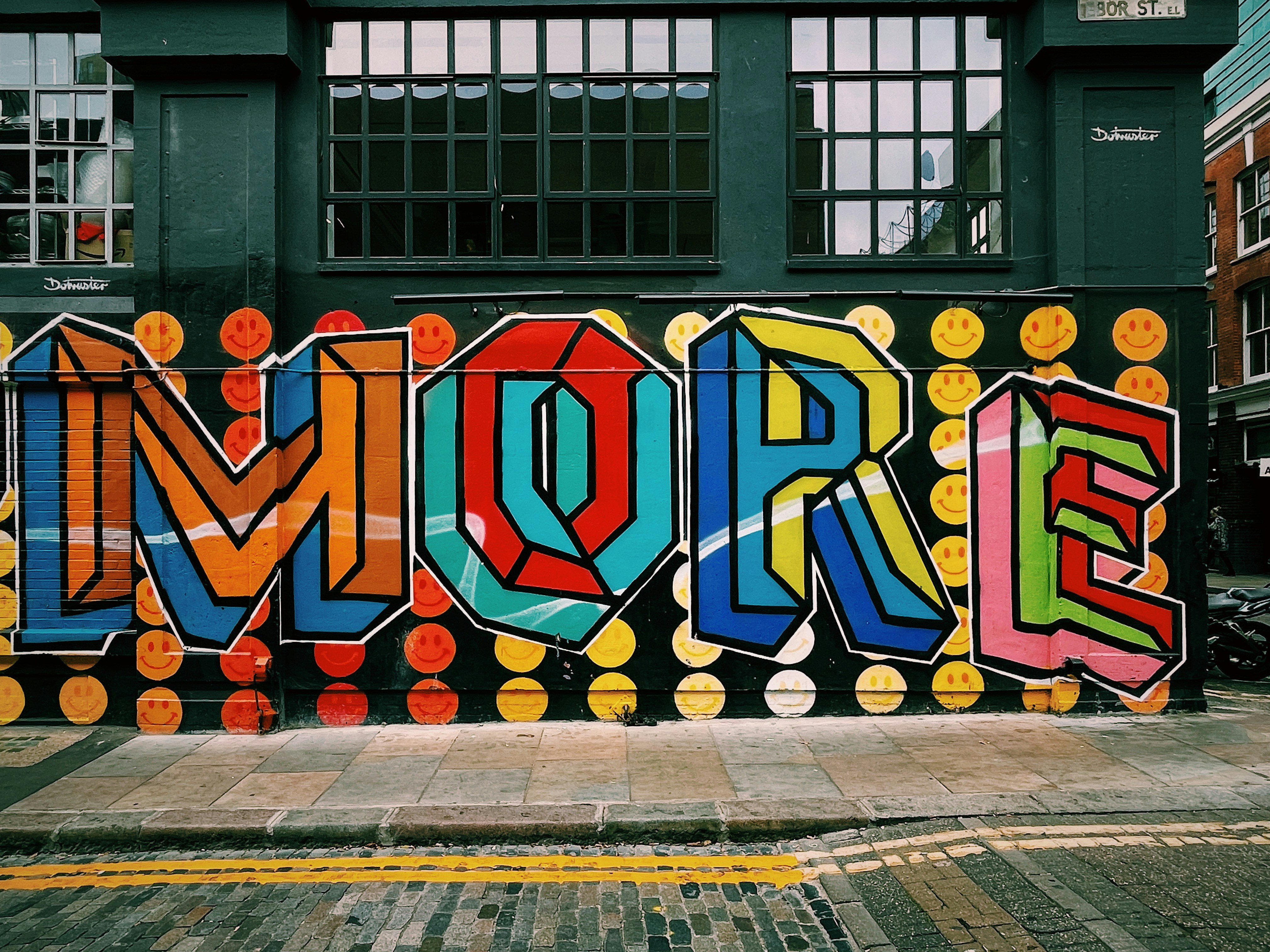 a large colorful piece of art on the side of a building