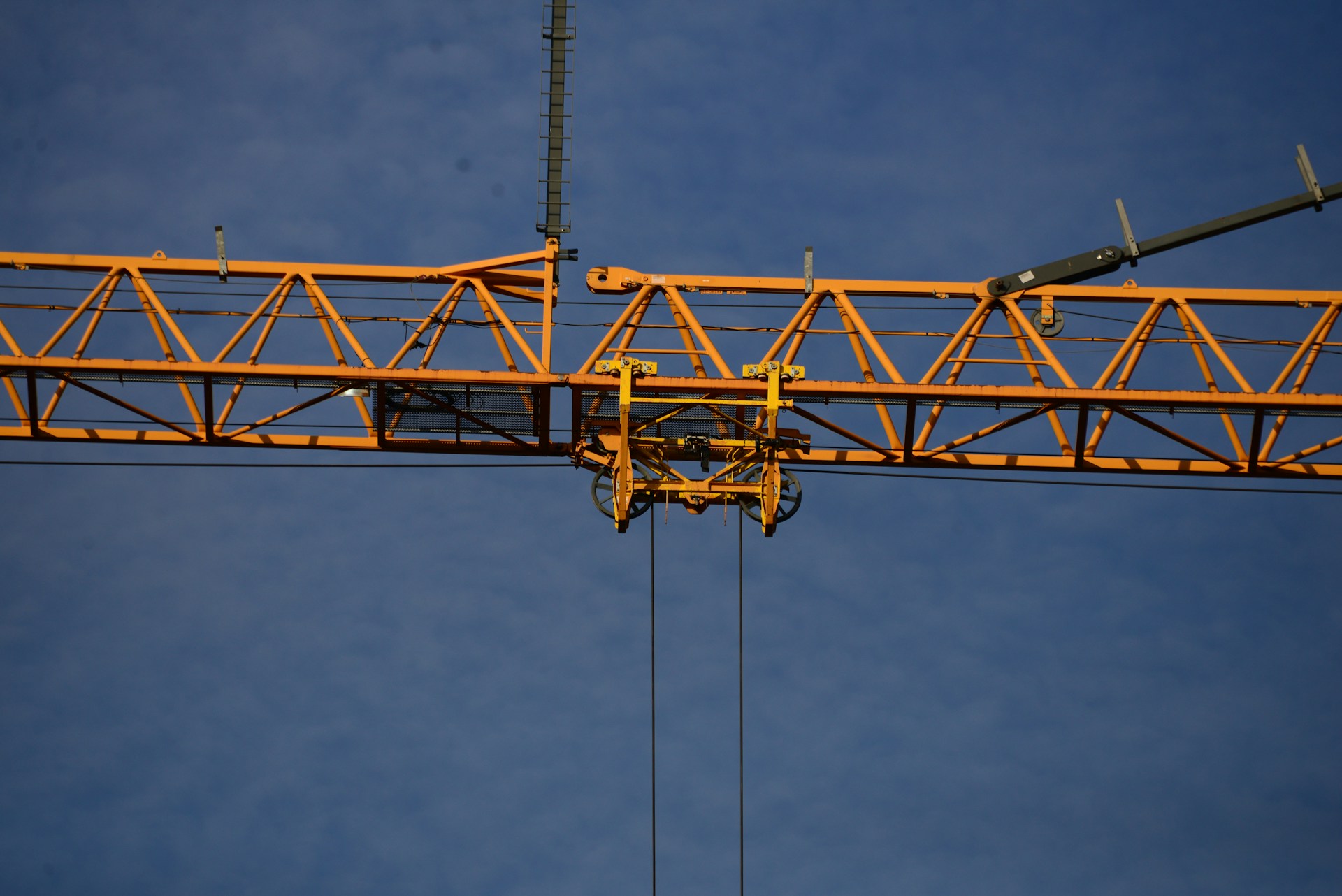 a yellow crane with a blue sky in the background