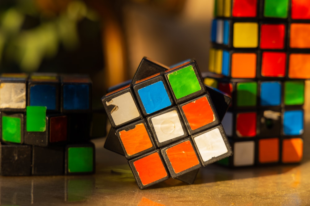 a group of colorful rubik cubes sitting on top of a table