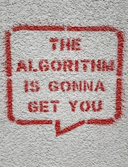 a red and white sign on a white wall