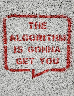 a red and white sign on a white wall