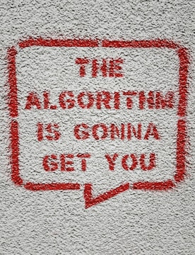 a red and white sign on a white wall
