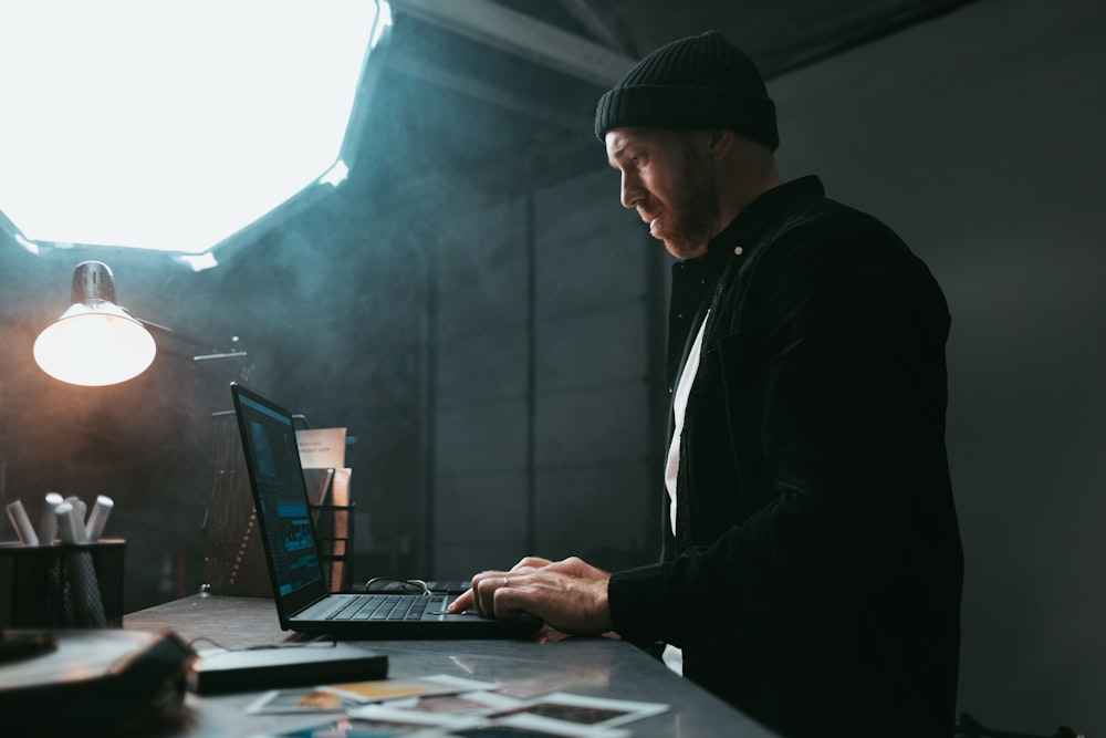 a man sitting in front of a laptop computer