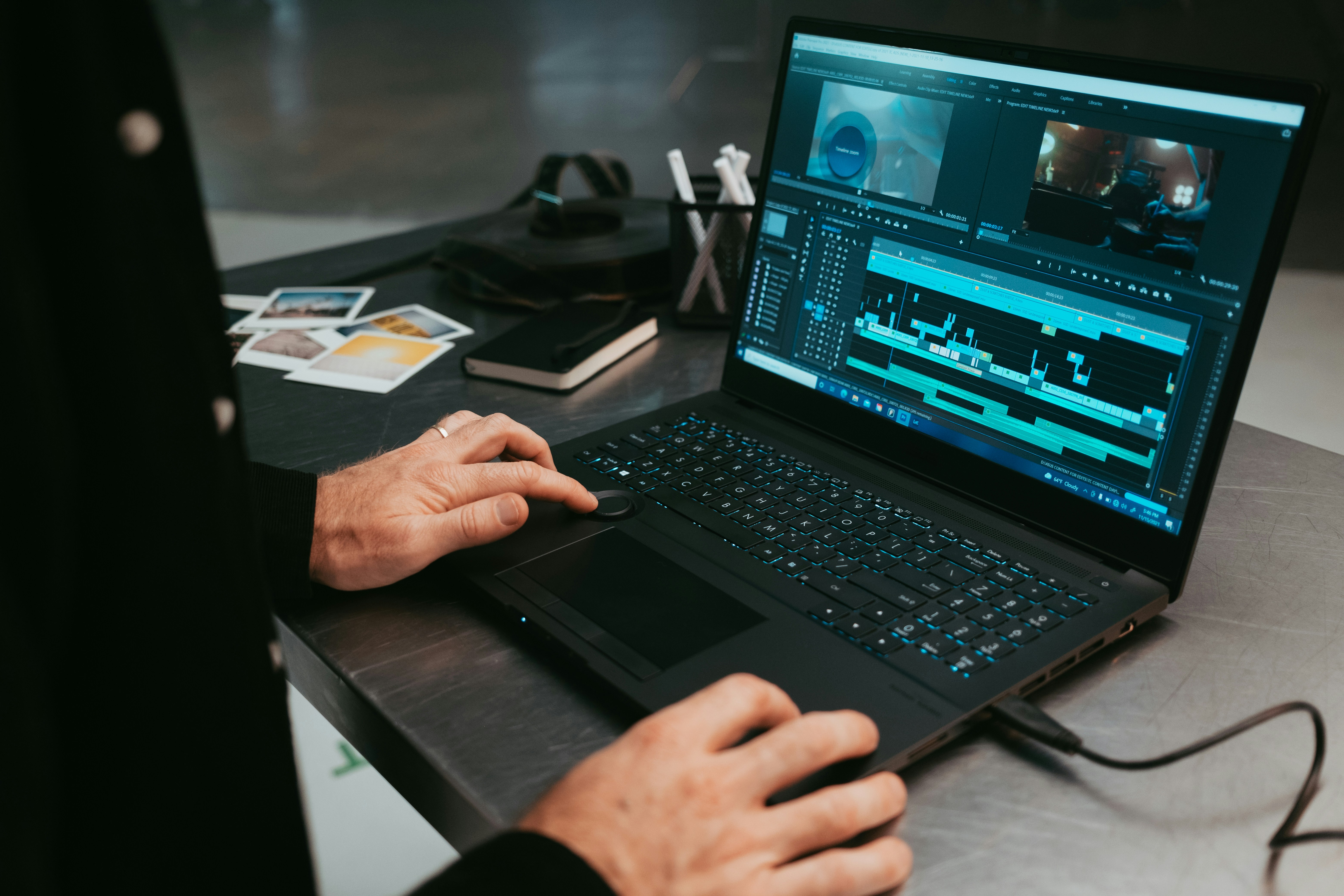 modern workstation laptop displaying video editing software timeline on desk