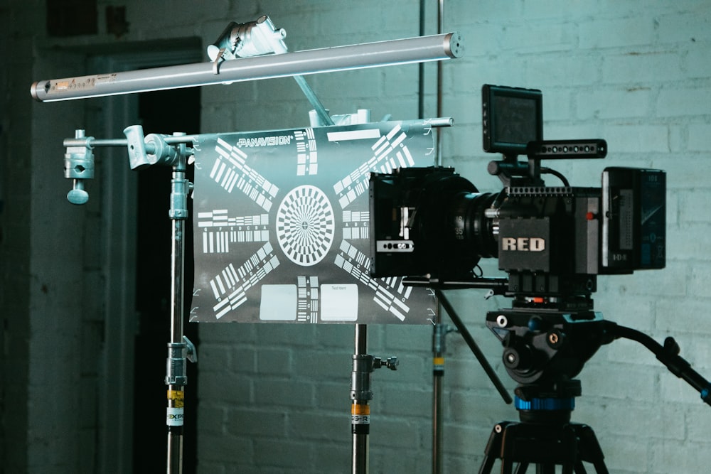 a camera set up in front of a brick wall