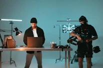 Behind-the-scenes shot of a content creator filming a social media video in a stylish studio.