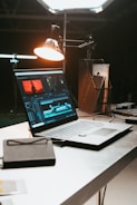 a laptop computer sitting on top of a desk